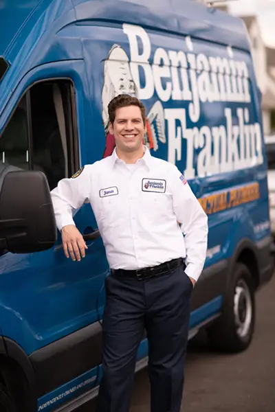 James, a Benjamin Franklin Plumbing Tech, outside of his van at a home in Fort Myers
