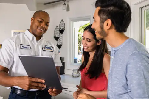 Benjamin Franklin Plumbing Tech, Trevor, With Homeowners in Fort Myers