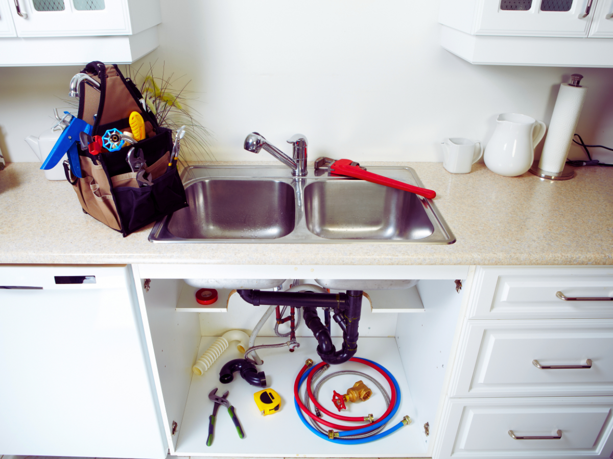 plumbing tools scattered around kitchen