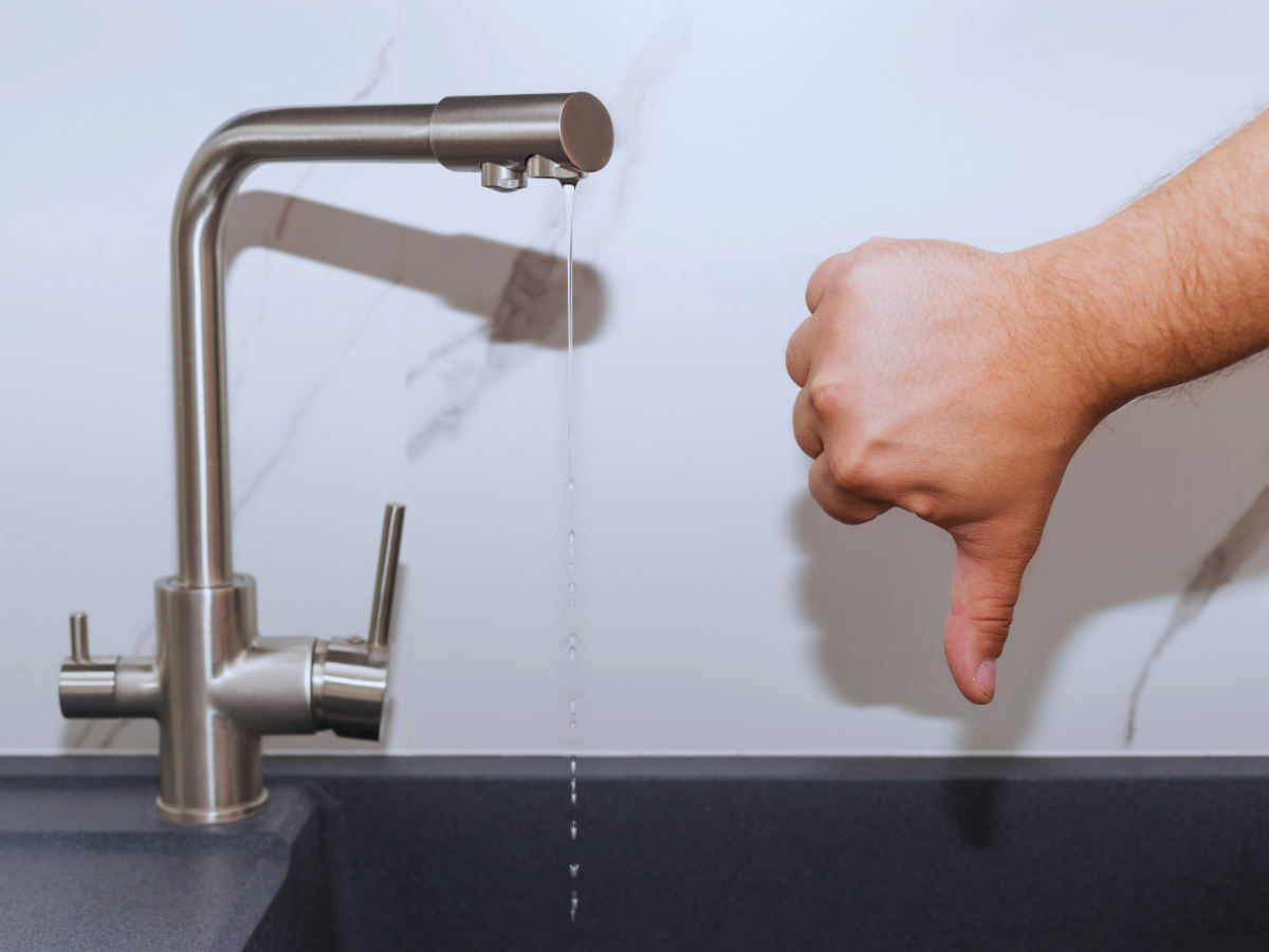 homeowner giving thumbs down to bad tasting tap water