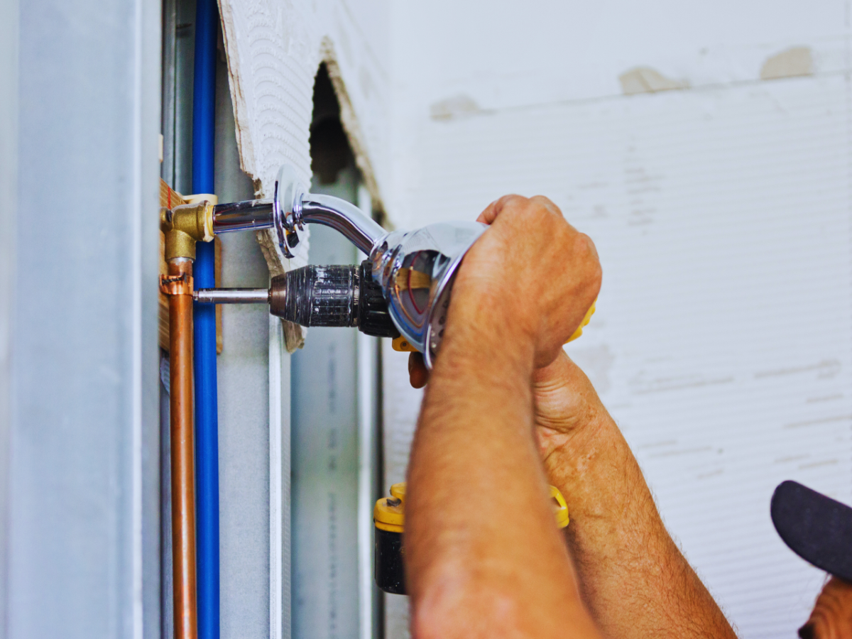 Plumber installing new showerhead 