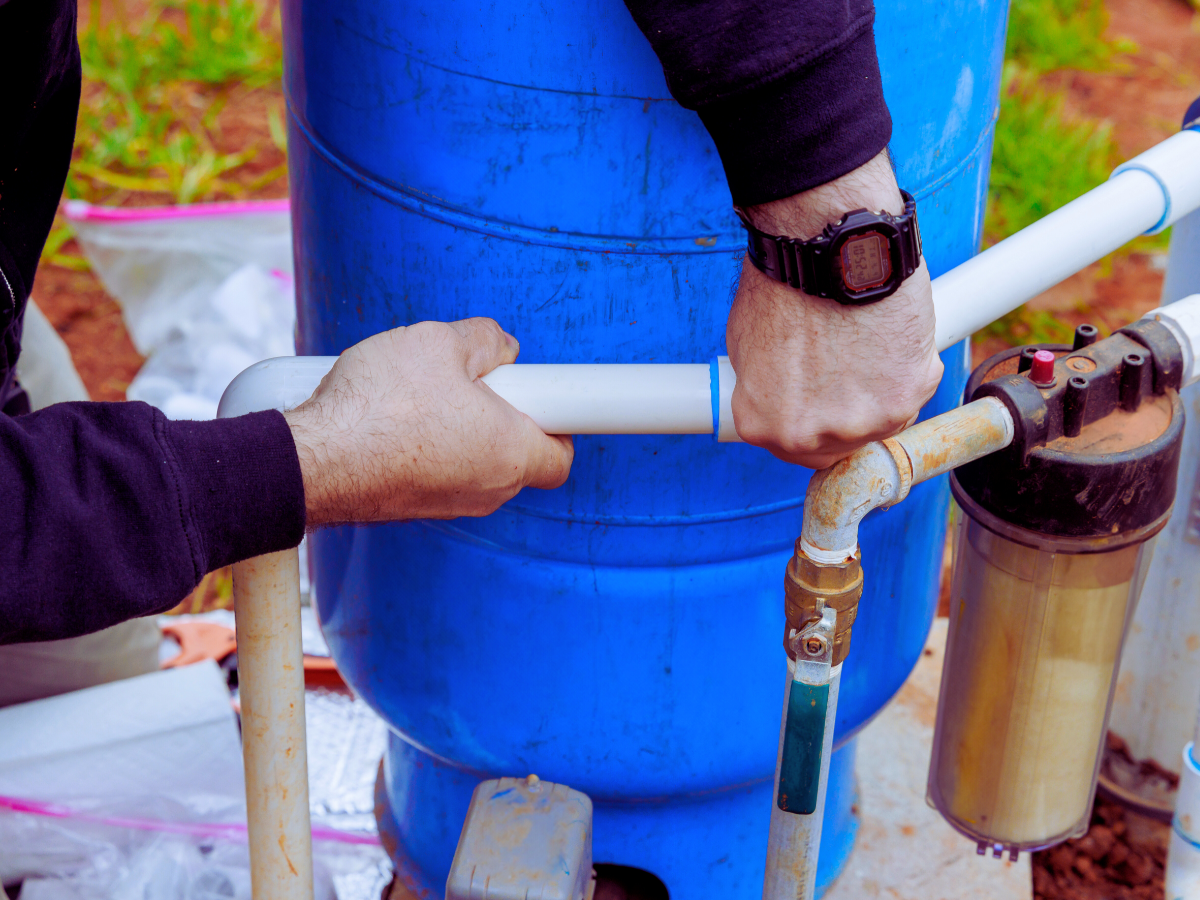 Plumber repairing well pump